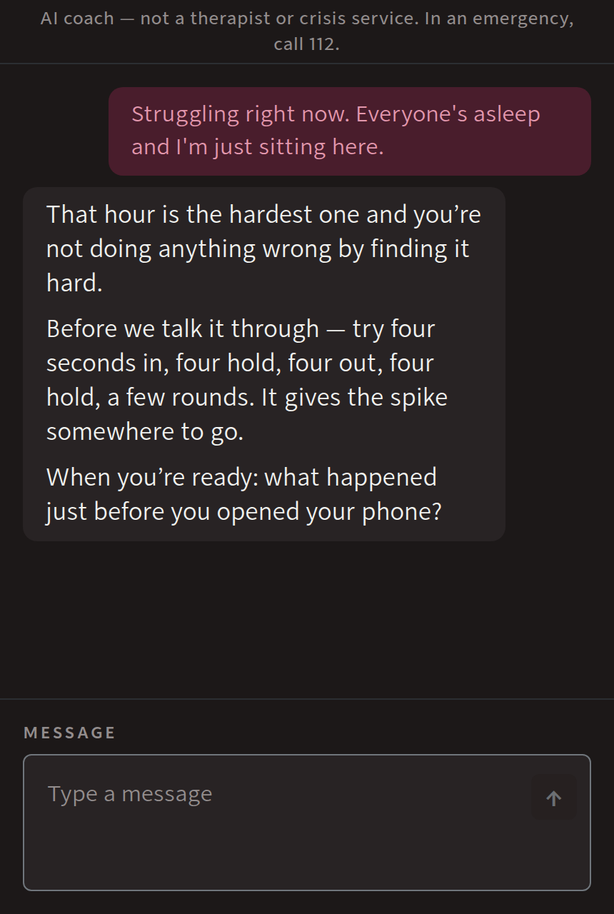 The WINNR AI coach in conversation: a man says he is struggling right now, the coach answers with a breathing step and asks what the trigger was. A line at the top reads: AI coach, not a therapist or crisis service.