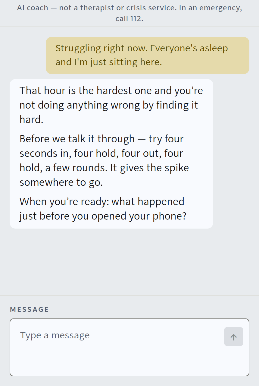 The WINNR AI coach in conversation: a man says he is struggling right now, the coach answers with a breathing step and asks what the trigger was. A line at the top reads: AI coach, not a therapist or crisis service.
